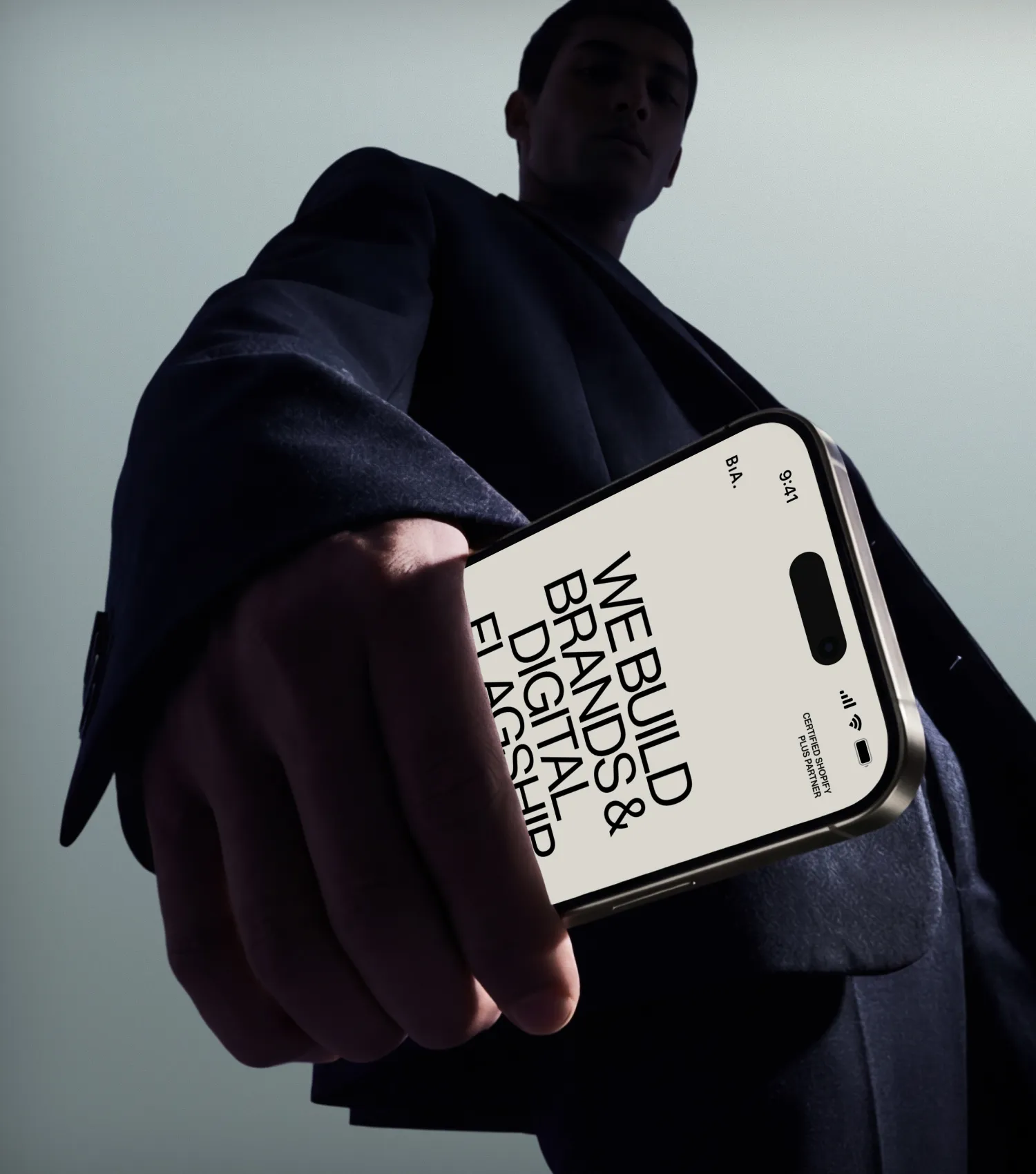 Man holds phone with BiA white paper on the screen