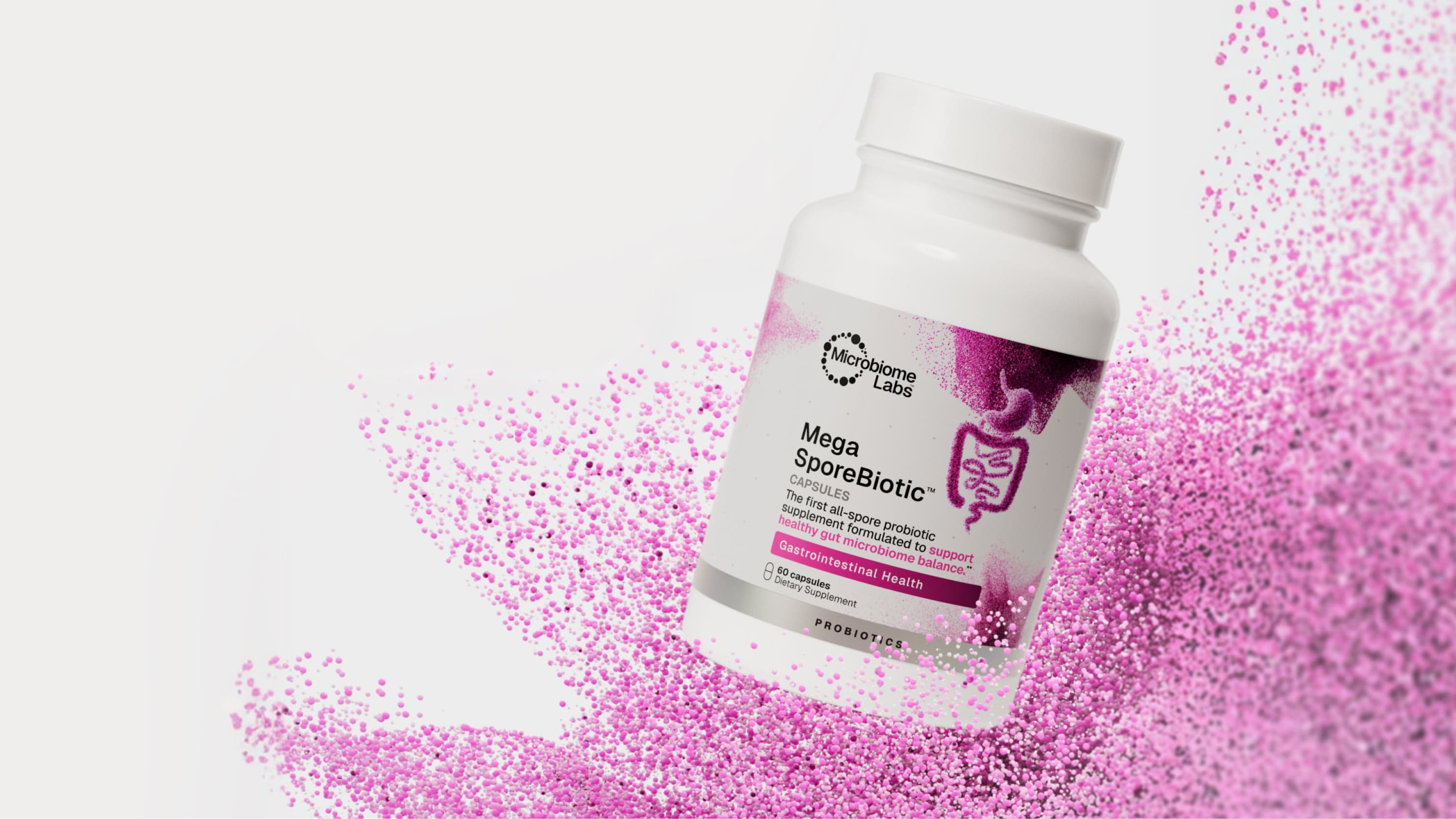 A white and pink container of Microbiome Labs Mega SporeBiotic is floating against a light grey background with dark and pale pink particules.