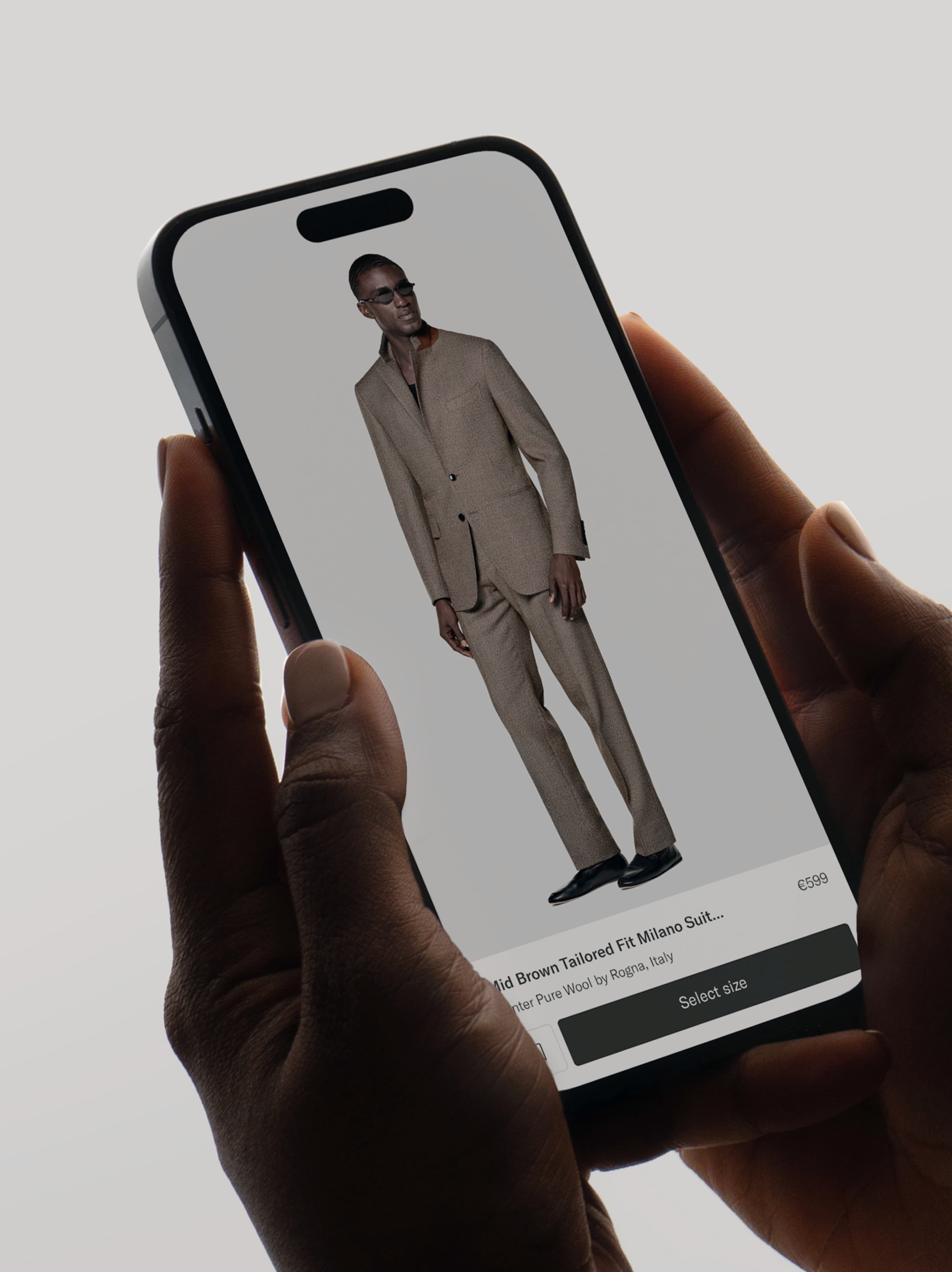 Hands holding a smartphone displaying the Suitsupply product detail page.